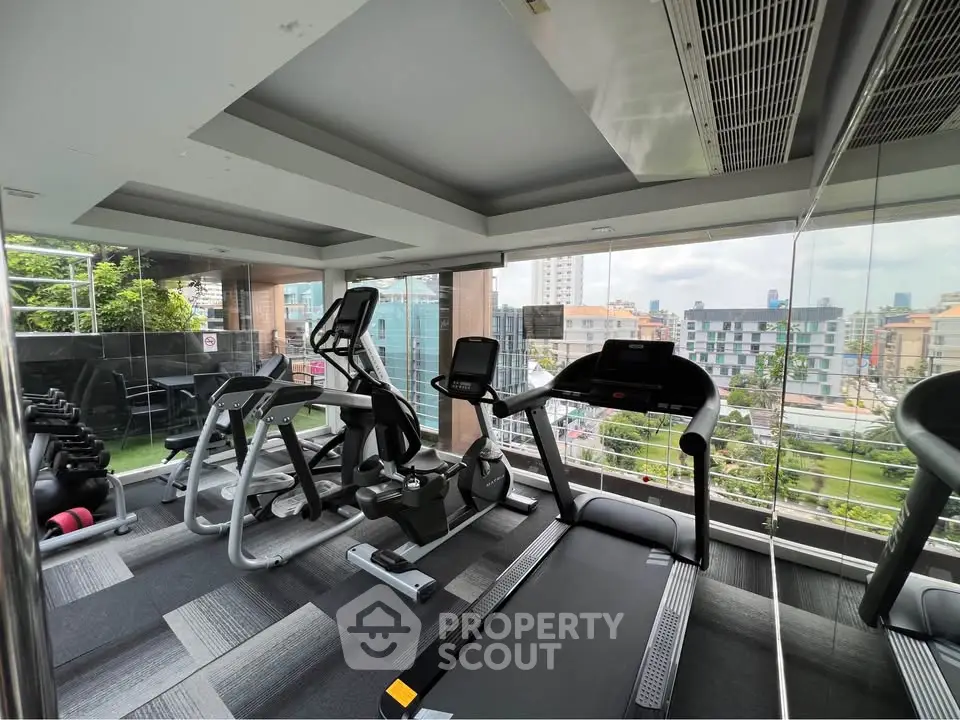 Modern gym with city view and state-of-the-art fitness equipment