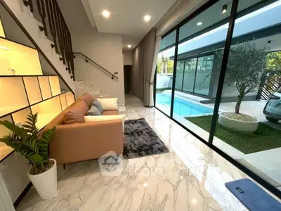 Luxurious modern living room with pool view and elegant marble flooring