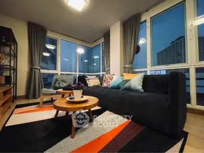 Stylish modern living room with large windows and cozy decor