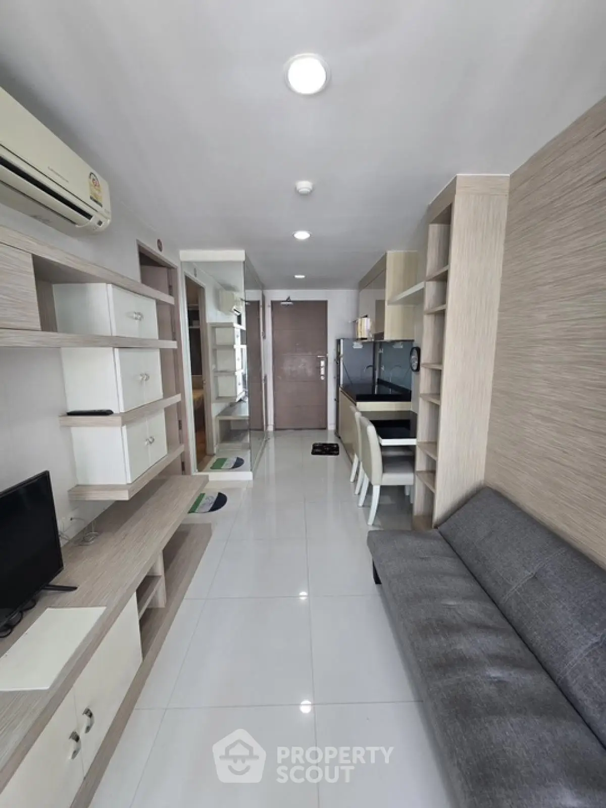 Modern apartment interior with sleek design and open layout, featuring a cozy living area and stylish furnishings.