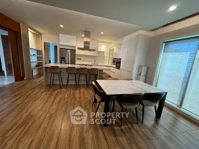 Spacious modern kitchen with open layout and sleek dining area