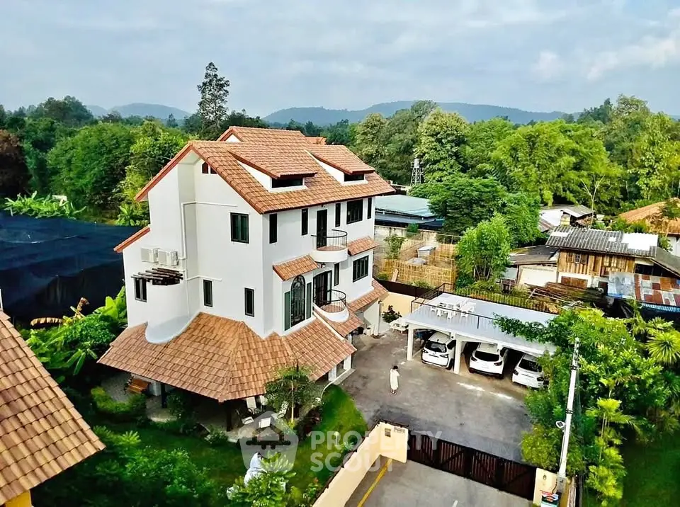 Charming multi-story house with tiled roof and lush greenery in serene neighborhood