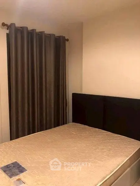 Cozy bedroom with elegant curtains and comfortable bed, perfect for restful nights.