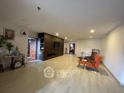Spacious living room with modern decor and open layout, featuring stylish furniture and ample natural light.