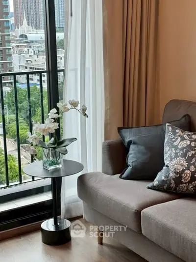 Stylish living room with cozy sofa and balcony view in modern apartment.
