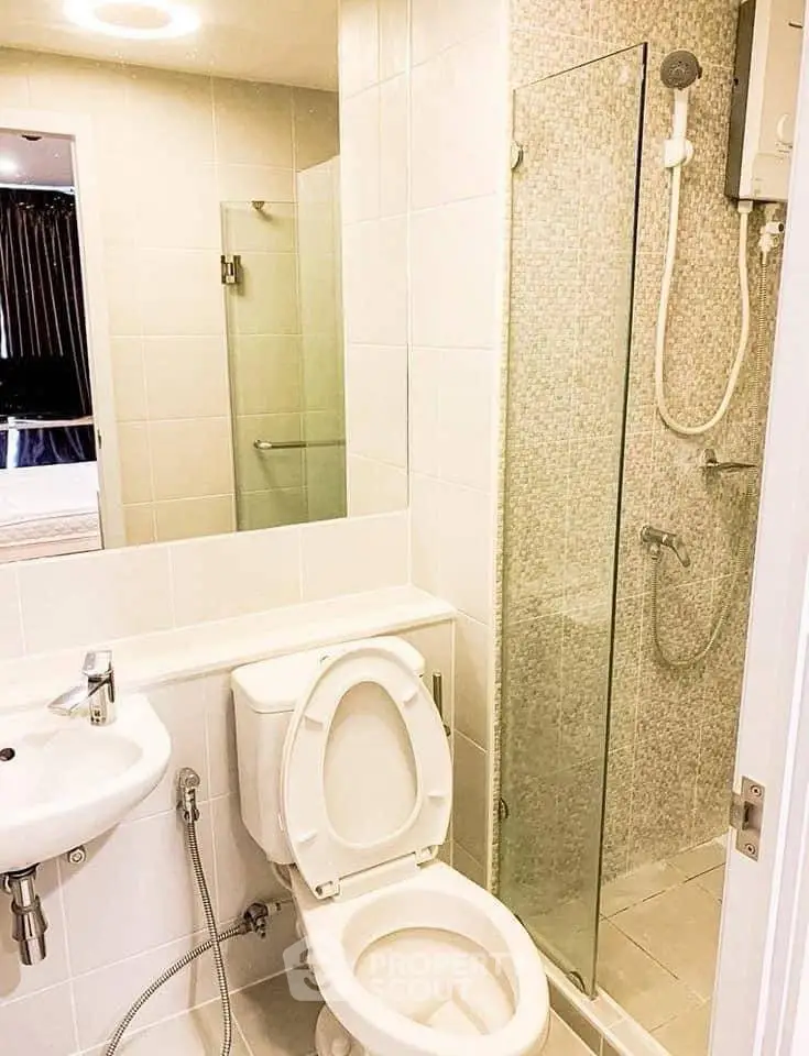 Modern bathroom with glass shower and sleek fixtures in a contemporary apartment.
