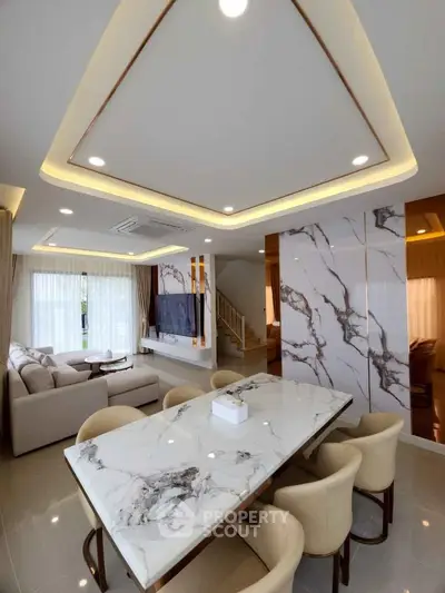 Luxurious modern living room with marble accents and elegant dining area