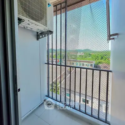 Charming balcony with scenic view and air conditioning unit, perfect for relaxation.