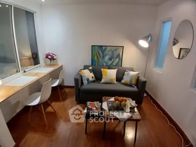 Cozy living room with modern decor, featuring a stylish sofa, chic lighting, and a functional workspace.