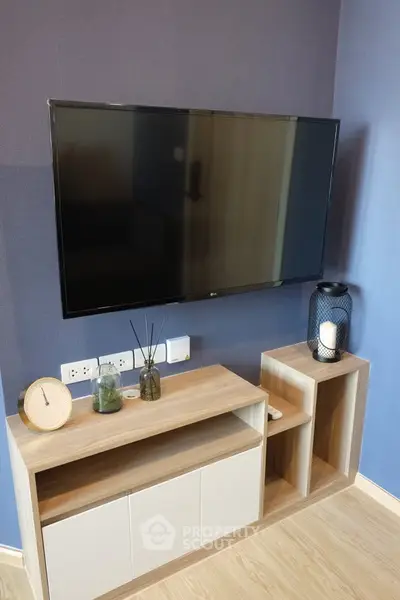 Modern living room with sleek TV setup and stylish wooden cabinet