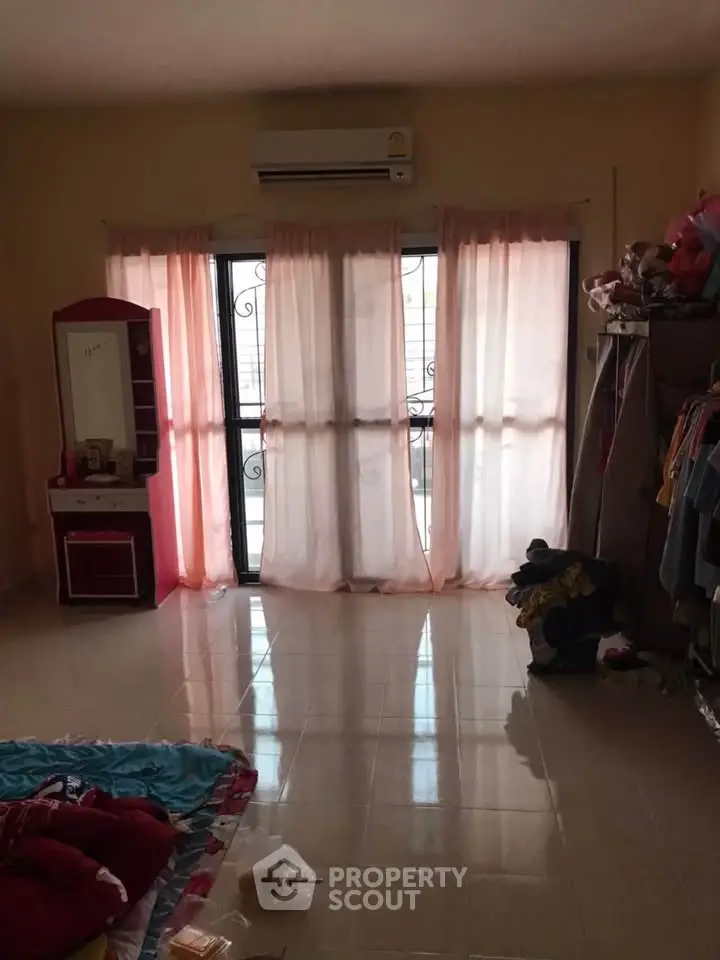 Spacious bedroom with balcony access and natural light