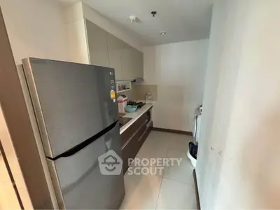 Modern kitchen with sleek fridge and ample storage space