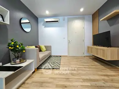 Modern living room with sleek design, featuring a cozy sofa, wall-mounted TV, and stylish decor.