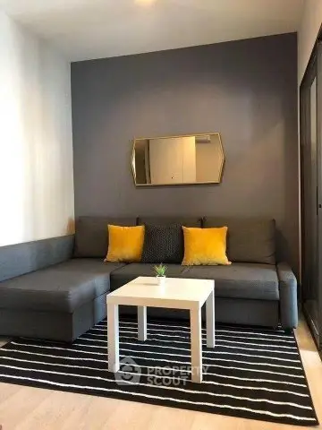 Modern living room with gray sofa, yellow cushions, and stylish decor
