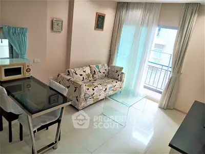 Bright living room with floral sofa and glass coffee table, adjacent to a small balcony.