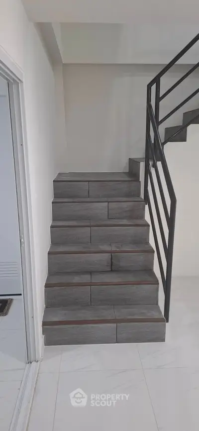 Modern staircase with sleek metal railing in contemporary home