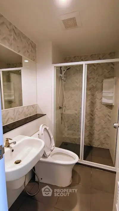 Modern bathroom with shower and sleek design in contemporary apartment.