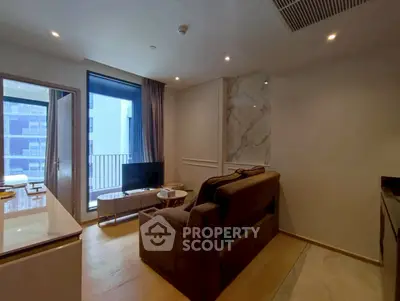 Modern living room with balcony access and stylish decor in urban apartment