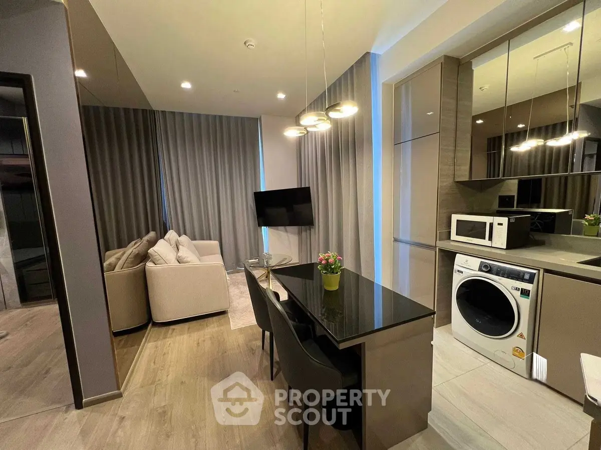 Modern open-plan living room with sleek kitchen and stylish decor