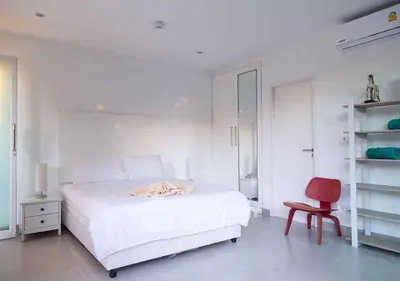 Bright and modern bedroom with minimalist decor and air conditioning