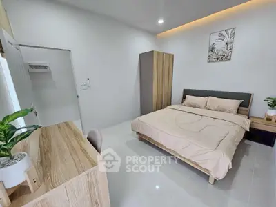 Modern bedroom with minimalist decor and cozy bed in a stylish apartment.
