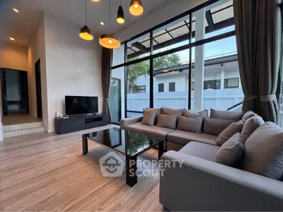 Spacious modern living room with large windows and stylish furniture