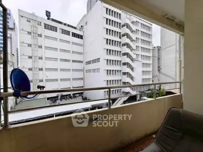 Urban balcony with city building view, ideal for modern living.