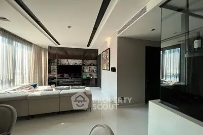 Spacious modern living room with large windows and elegant decor