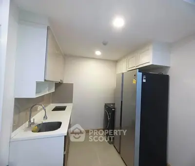 Modern kitchen with sleek appliances and ample storage space