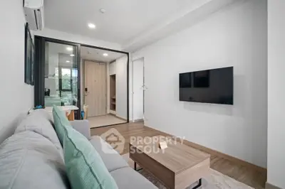 Modern living room with sleek design and wall-mounted TV in a cozy apartment.