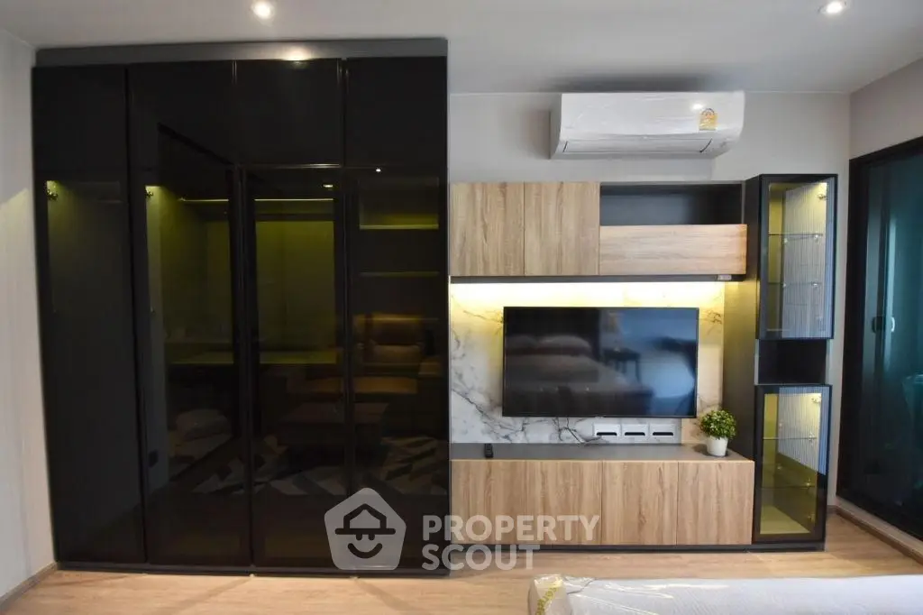 Modern living room with sleek black cabinets and stylish TV unit