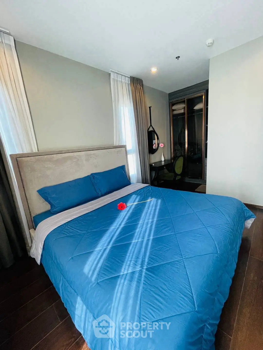 Spacious bedroom with modern decor and large bed in a stylish apartment.