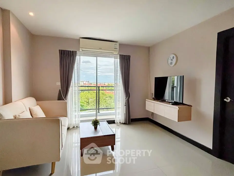 Modern living room with large window and scenic view, featuring sleek furniture and minimalist decor.