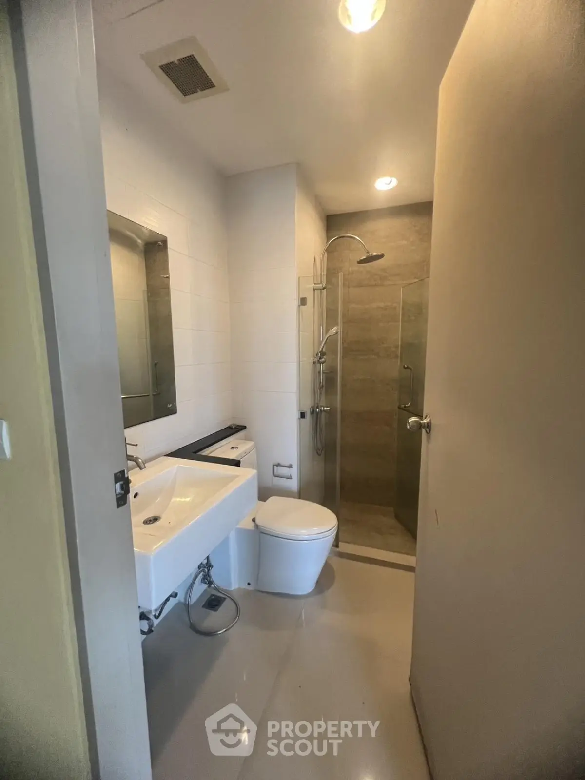 Modern bathroom with sleek fixtures and glass shower enclosure