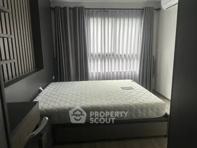 Modern bedroom with stylish decor and large window for natural light