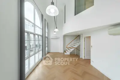 Spacious modern living room with high ceilings and large windows