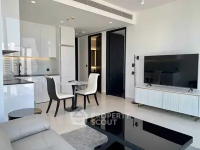 Modern open-plan living room with sleek kitchen and stylish furniture in a luxury apartment.