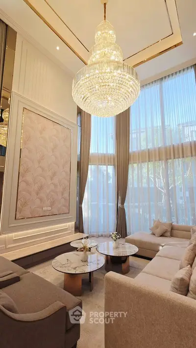 Luxurious living room with elegant chandelier and floor-to-ceiling windows