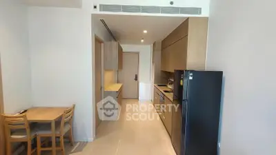 Modern kitchen with sleek cabinetry and dining area in a stylish apartment
