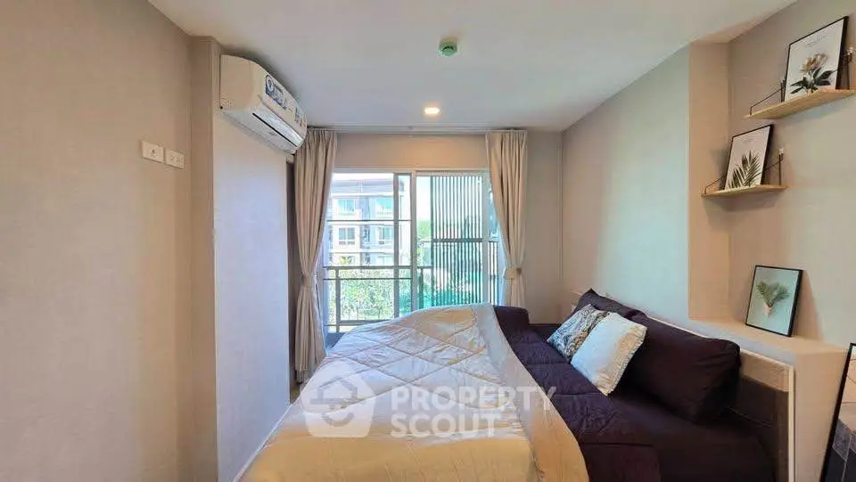 Cozy bedroom with modern decor and large window offering natural light