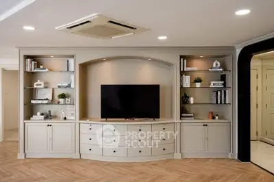 Elegant living room with built-in shelves and modern TV setup