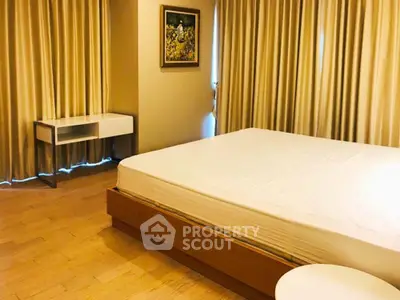 Spacious bedroom with elegant decor and natural light, featuring a modern bed and stylish curtains.