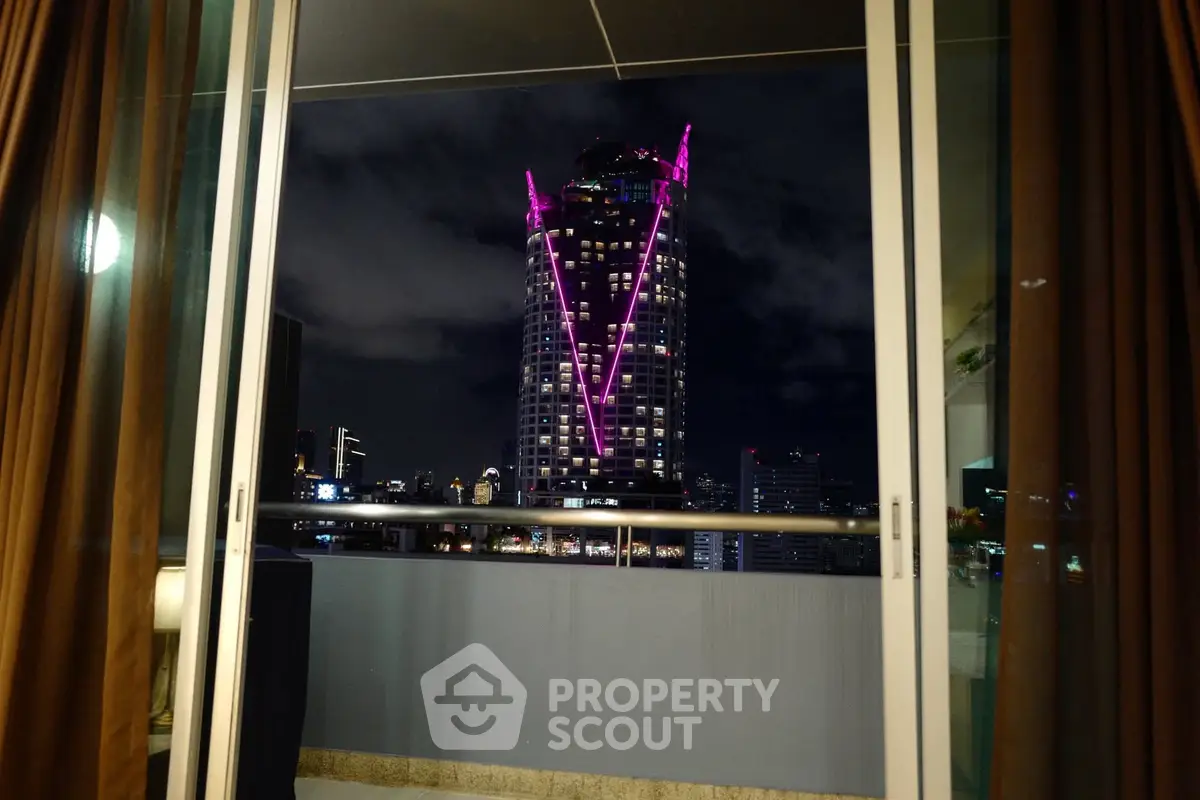 Stunning city view from a modern balcony with illuminated skyscraper