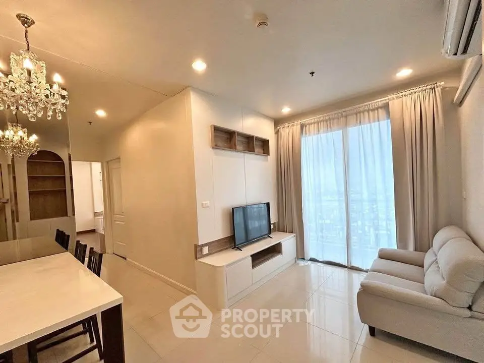 Modern living room with elegant chandelier and large window view