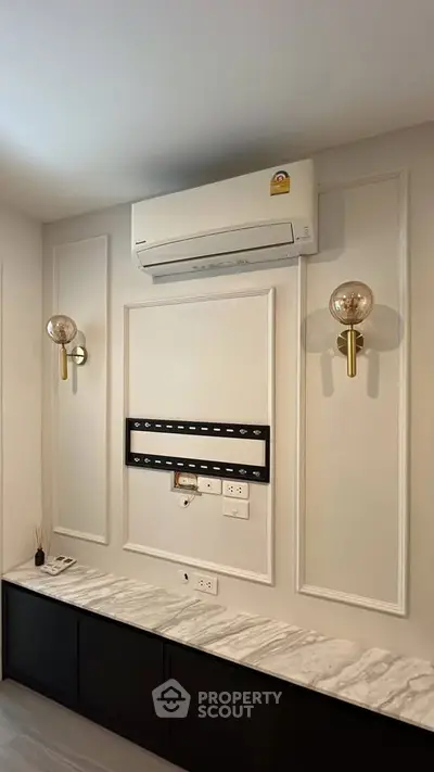 Modern interior wall with air conditioning and elegant lighting fixtures.