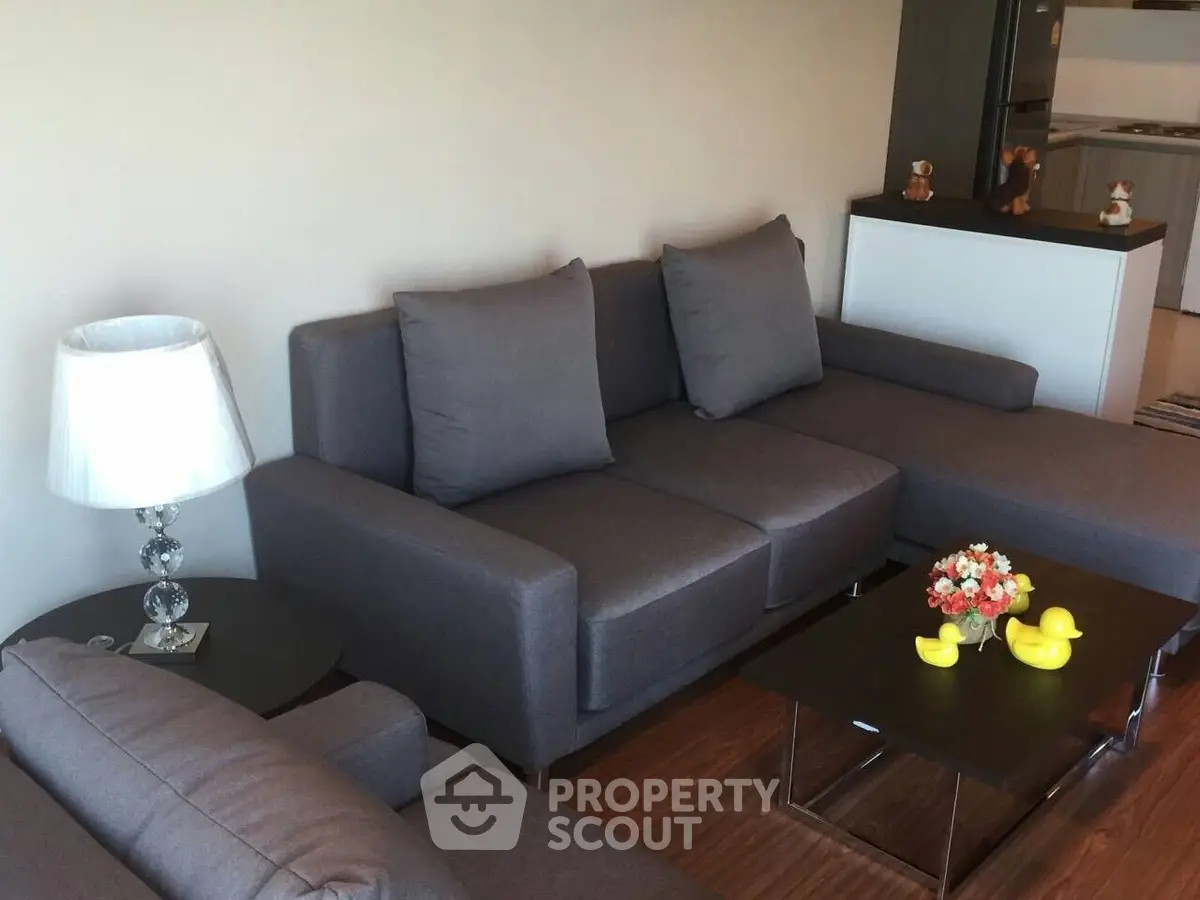 Modern living room with stylish gray sofa and elegant decor