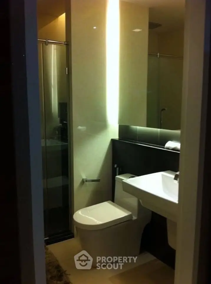 Modern bathroom with sleek fixtures and glass shower enclosure