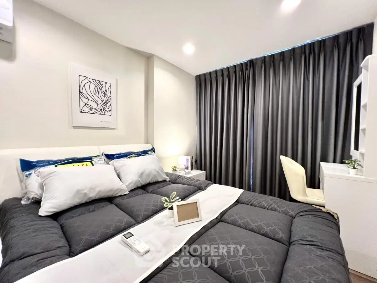 Modern bedroom with stylish decor and cozy bedding in a contemporary apartment.