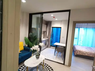 Modern open-plan living room with stylish decor and cozy bedroom view
