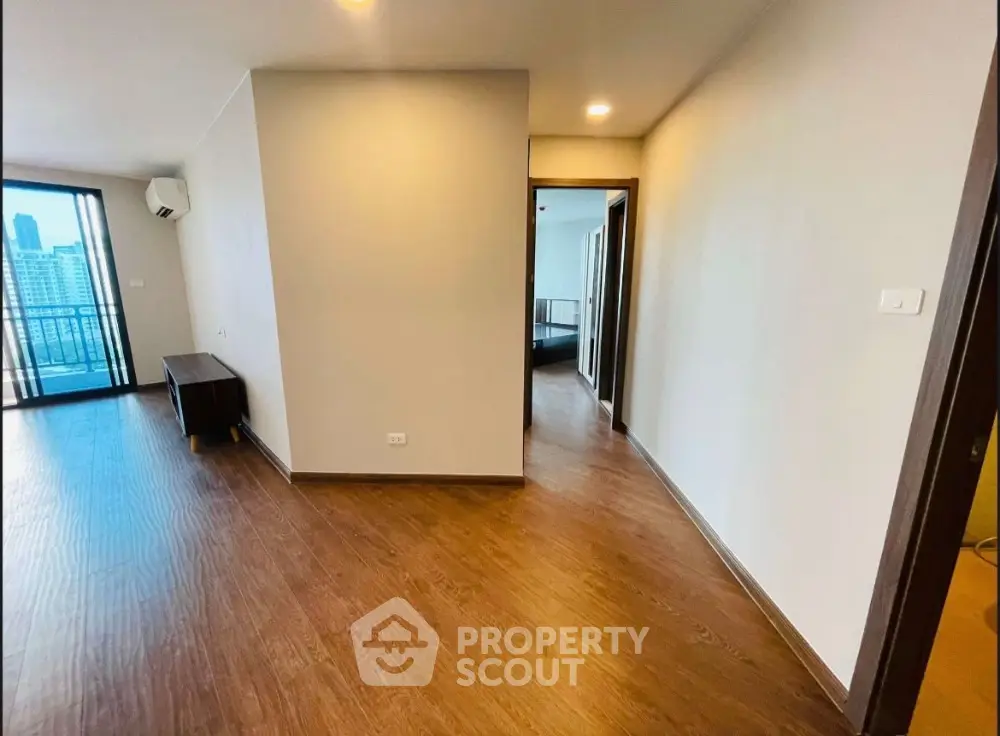 Spacious modern apartment with wooden flooring and city view balcony